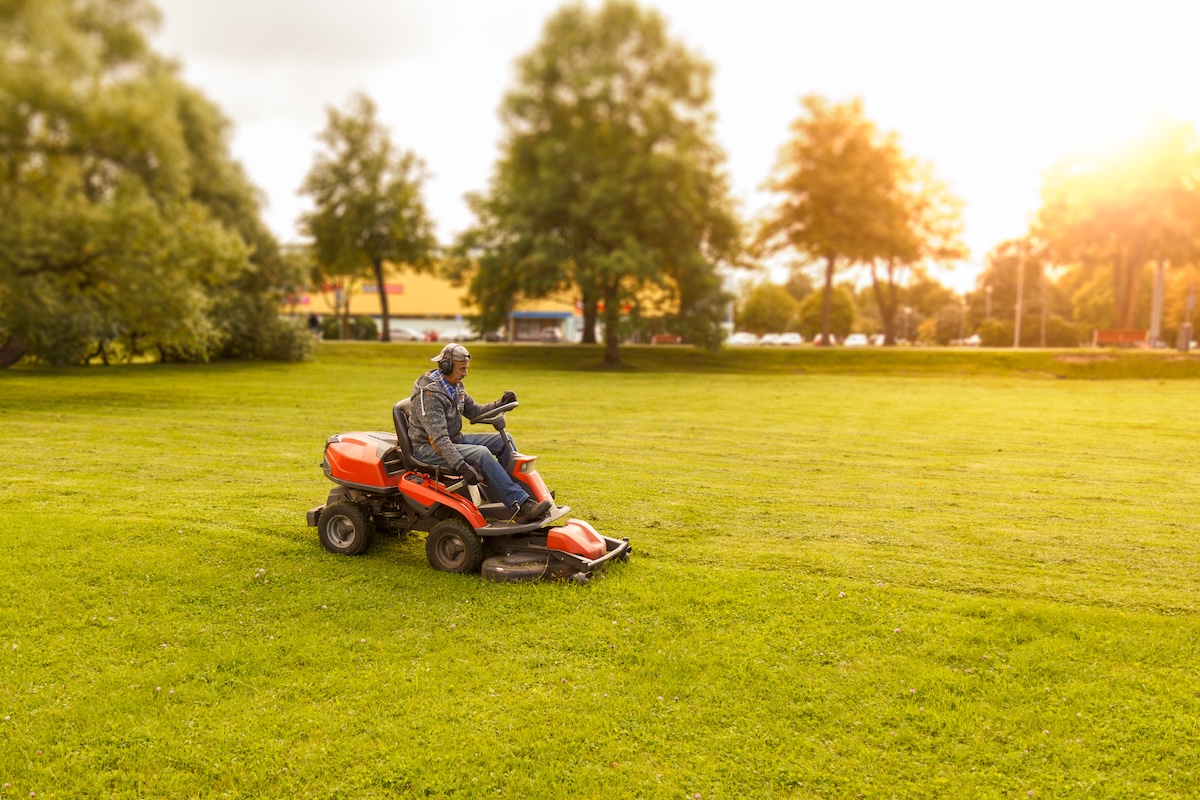 lawn mower tractor working in the town park